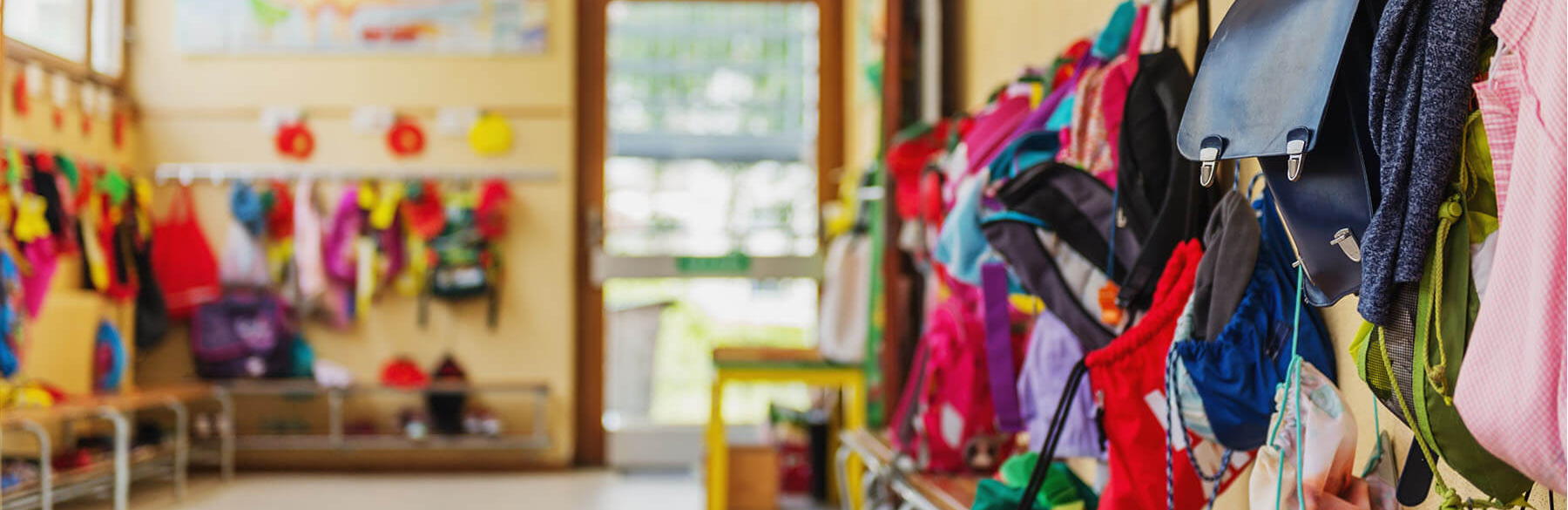 school entryway with coats and backpacks on hooks