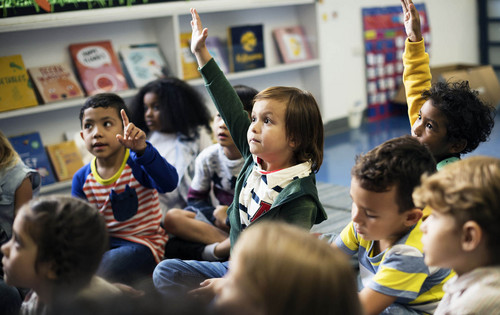 young student raising their hand
